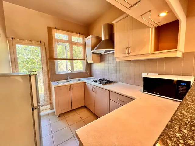 A lodge kitchen with a gas hob, a microwave and a fridge.